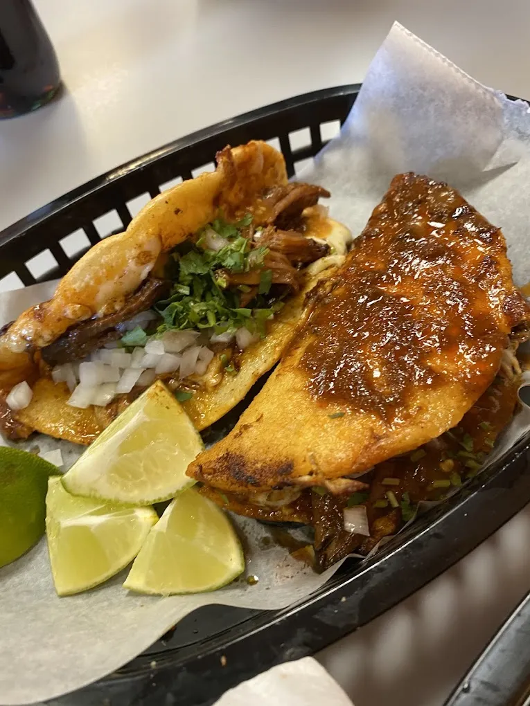 A taco and a folded quesabirria in a basket